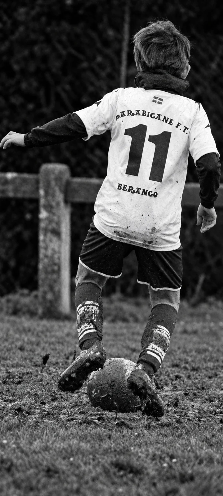 Unai wearing number 11, pictured in black and white during a youth soccer match.